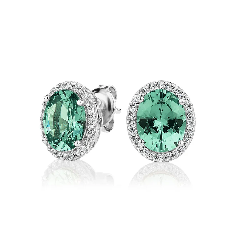 women's luxury earrings-Oval and Round Brilliant halo stud earrings with ocean green simulants and 0.34 carats* of diamond simulants