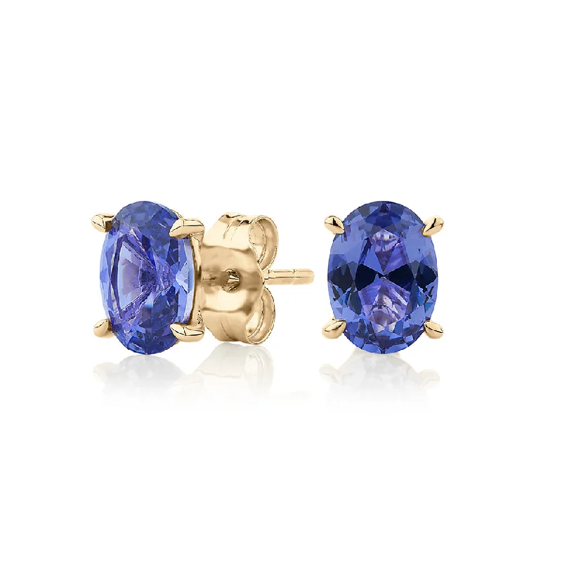 women's dangly earrings-Oval stud earrings with tanzanite simulants in 10 carat yellow gold