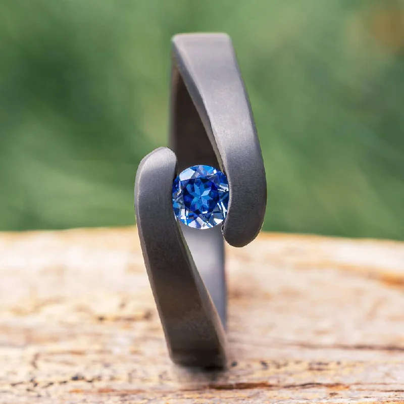 women's custom engagement rings-Tension Set Blue Sapphire in Black Zirconium Engagement Ring