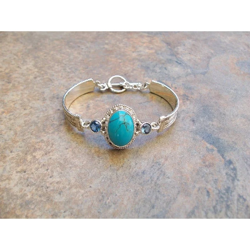 women's wooden bangles-REVE Large Oval Turquoise  Hinged Sterling Silver and 14kt Bracelet with Blue Topaz